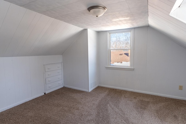 bonus room with vaulted ceiling, carpet, visible vents, and baseboards