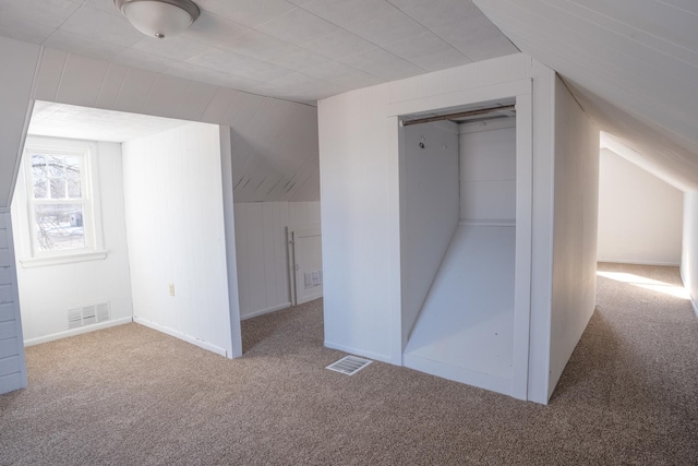 unfurnished bedroom featuring carpet, visible vents, and a closet