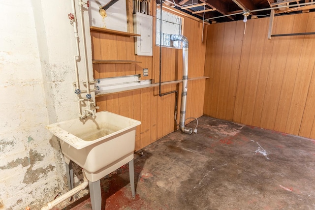 basement with electric panel and wood walls