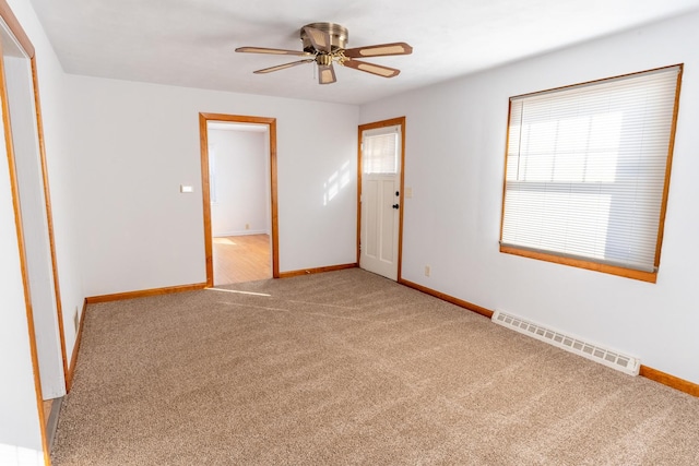 unfurnished room featuring visible vents, baseboards, ceiling fan, and carpet flooring