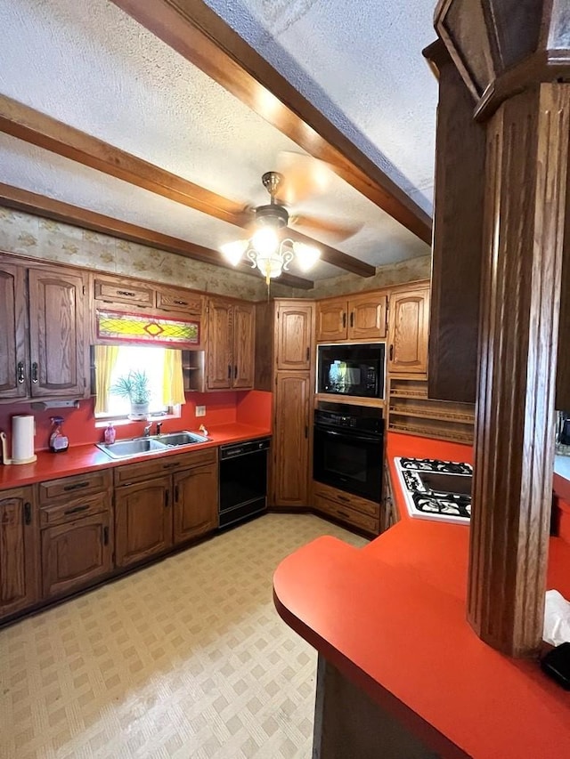 kitchen featuring beamed ceiling, sink, ceiling fan, black appliances, and a textured ceiling