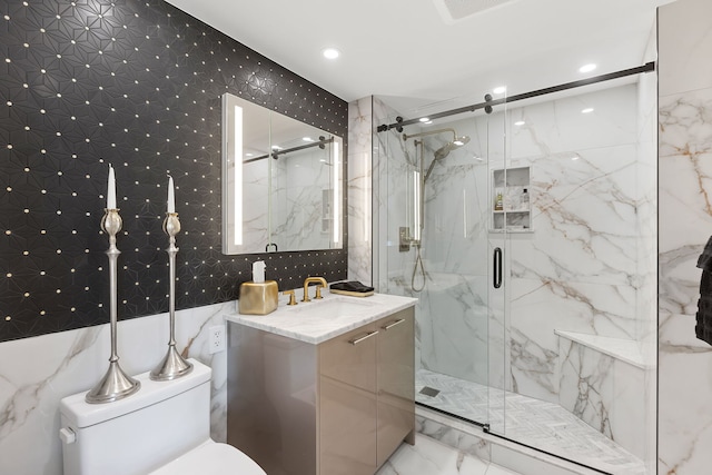 bathroom with walk in shower, vanity, and toilet