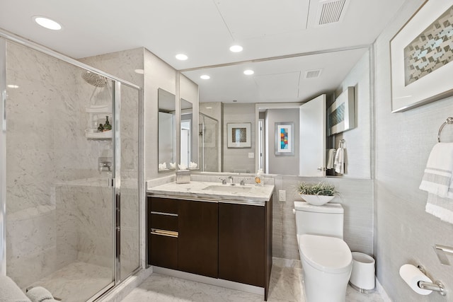 bathroom with vanity, a shower with shower door, and toilet