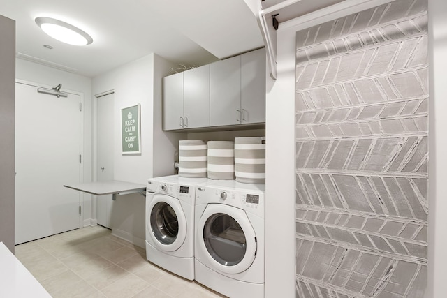 laundry room with cabinets and washer and dryer