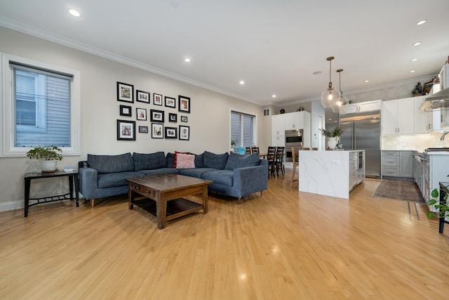 living room with crown molding and light hardwood / wood-style floors