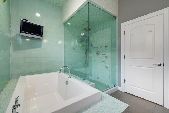 bathroom with shower with separate bathtub and tile patterned floors