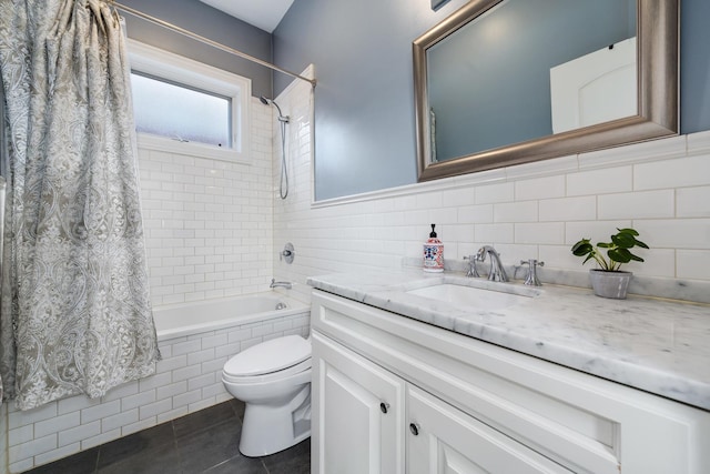 full bathroom featuring tile walls, shower / bath combination with curtain, vanity, toilet, and tile patterned floors