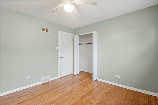 unfurnished bedroom with ceiling fan, a closet, and light hardwood / wood-style flooring