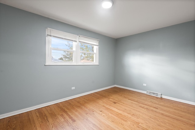 unfurnished room with light hardwood / wood-style floors