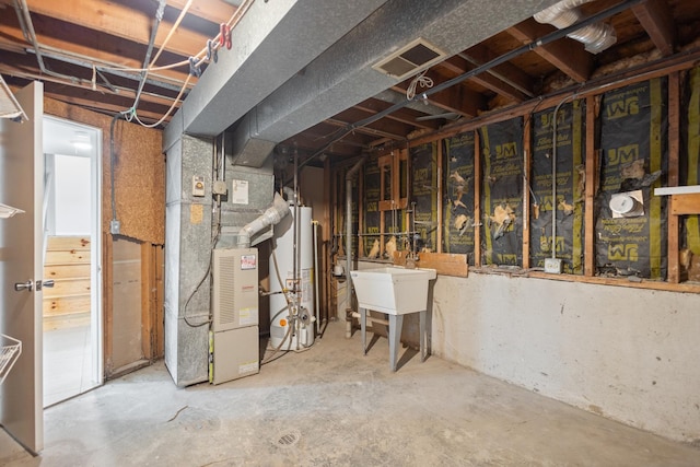 basement with heating unit, sink, and gas water heater