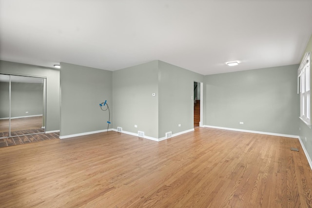 empty room with light hardwood / wood-style floors