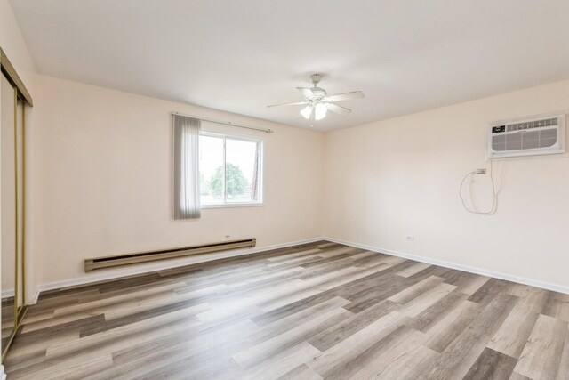 empty room with baseboard heating, ceiling fan, light hardwood / wood-style floors, and a wall unit AC