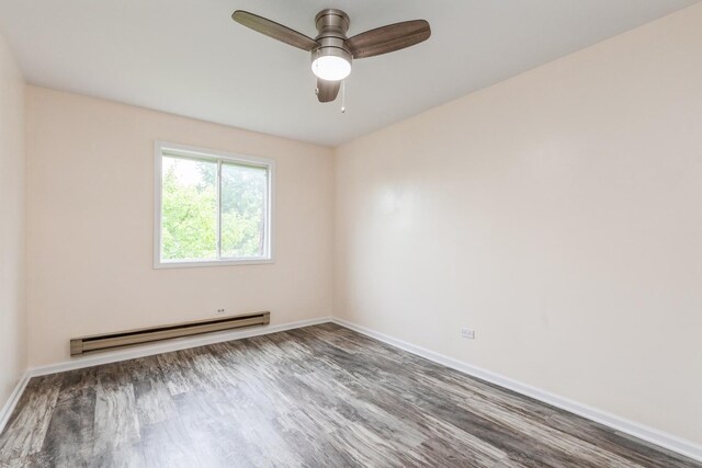 empty room with ceiling fan, hardwood / wood-style floors, and a baseboard heating unit