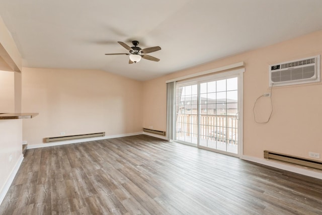 unfurnished living room featuring wood-type flooring, a baseboard radiator, a wall mounted AC, and vaulted ceiling