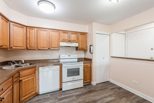 kitchen with dark hardwood / wood-style flooring, sink, and white appliances