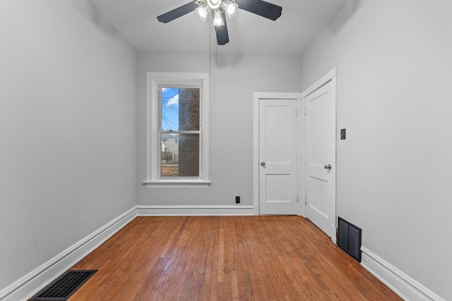 unfurnished room with hardwood / wood-style flooring and ceiling fan