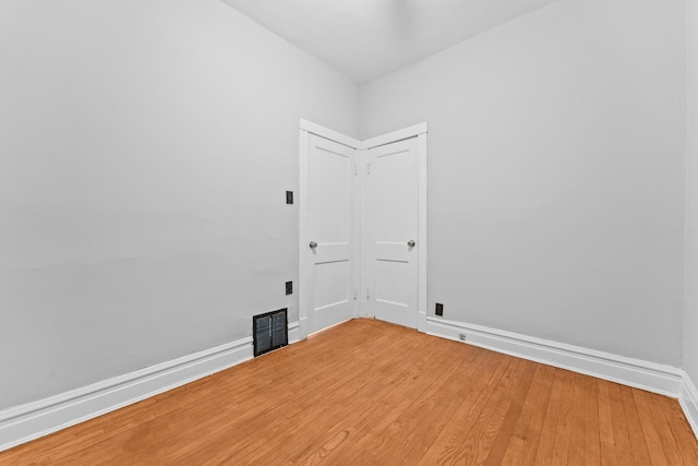 spare room with wood-type flooring