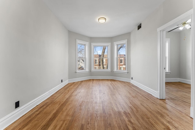 unfurnished room featuring ceiling fan and light wood-type flooring