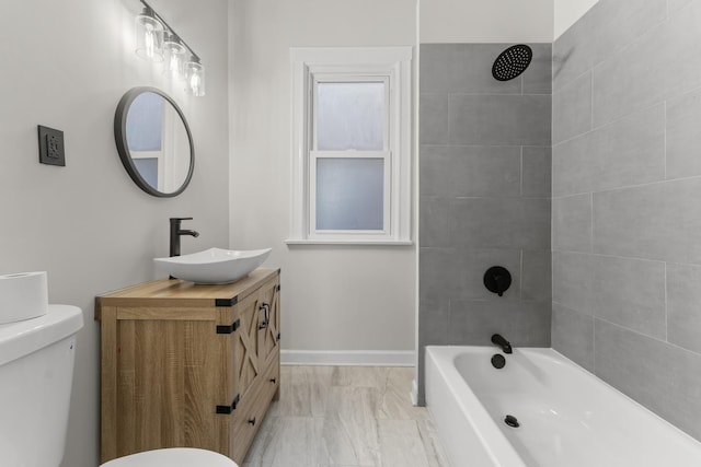 full bathroom with tiled shower / bath combo, vanity, and toilet