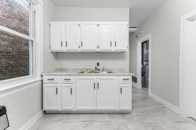 kitchen featuring sink and white cabinets