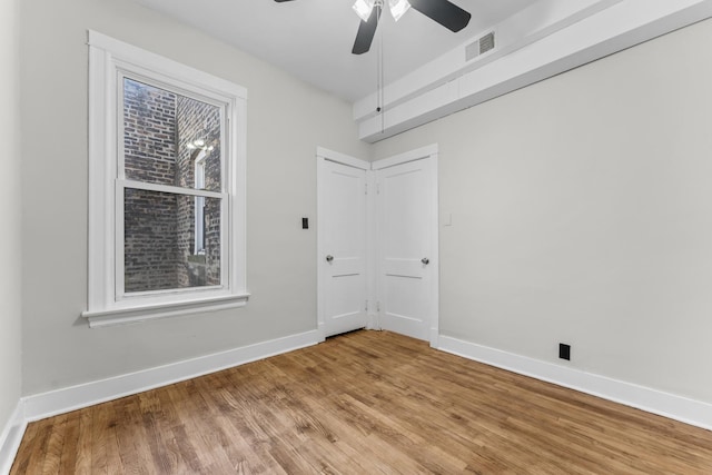 empty room featuring ceiling fan and wood-type flooring