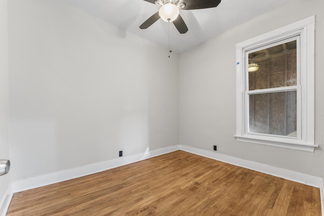 empty room with hardwood / wood-style flooring and ceiling fan