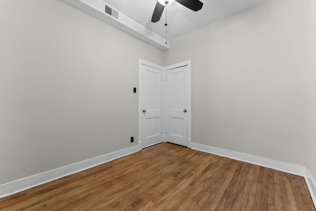 spare room with ceiling fan and wood-type flooring