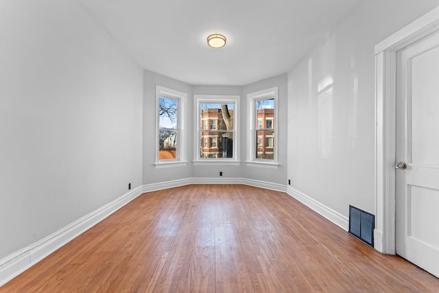 spare room featuring light wood-type flooring