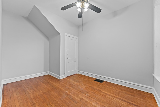 bonus room with hardwood / wood-style floors and ceiling fan