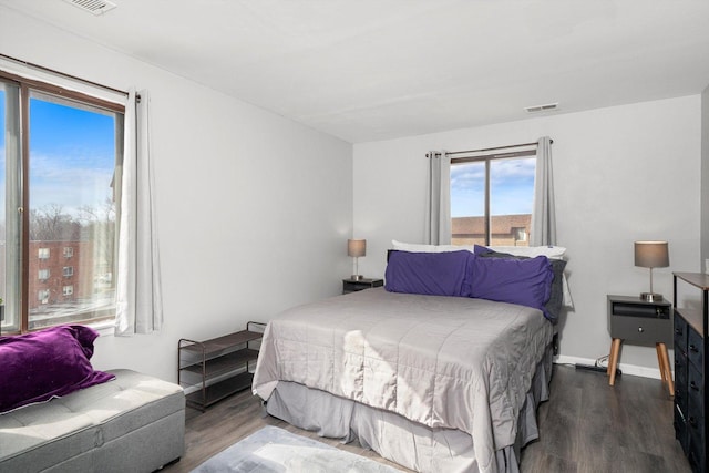 bedroom with dark wood-type flooring