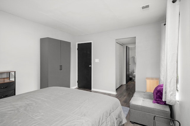 bedroom with dark wood-type flooring