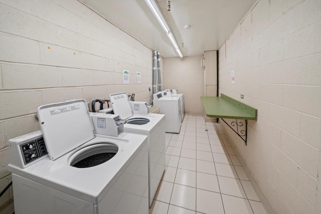 washroom featuring light tile patterned floors and washer and clothes dryer