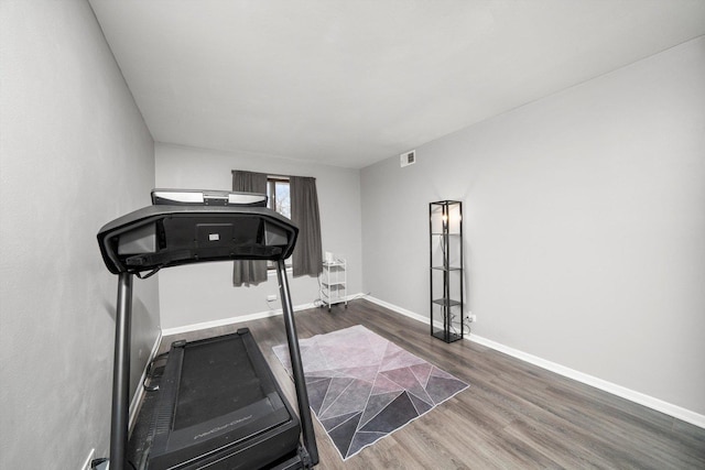 exercise area with dark wood-type flooring