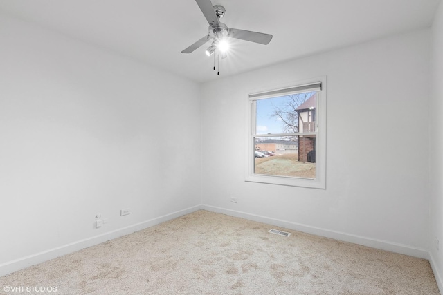 carpeted spare room with ceiling fan