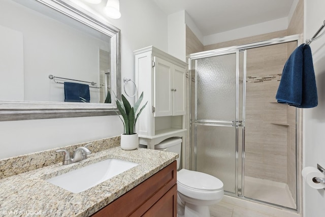 bathroom featuring vanity, toilet, and walk in shower