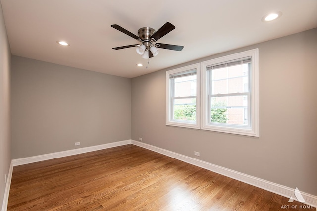 spare room with ceiling fan and wood-type flooring