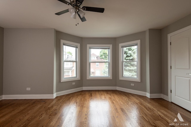 unfurnished room featuring hardwood / wood-style floors and ceiling fan