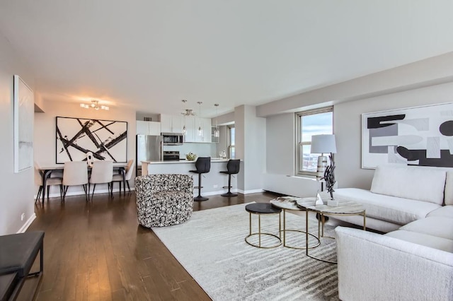 living room featuring sink and dark hardwood / wood-style flooring