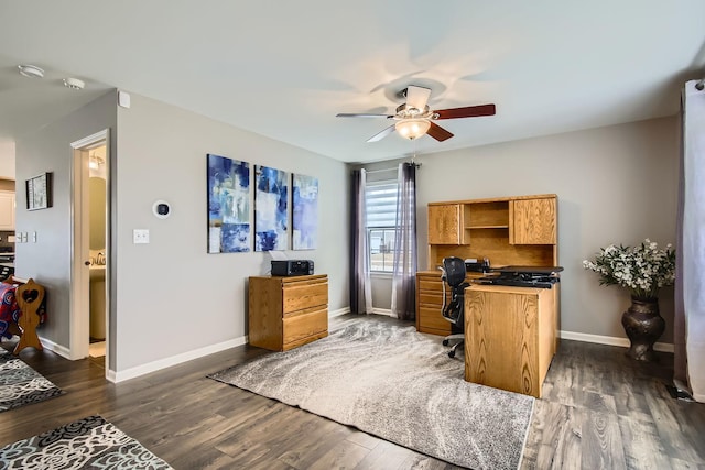 office area with ceiling fan and dark hardwood / wood-style floors