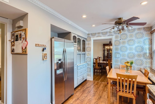 kitchen featuring crown molding, stainless steel fridge, ceiling fan, gray cabinetry, and hardwood / wood-style floors