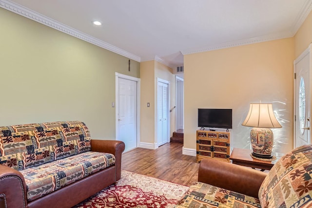 living room with crown molding and wood-type flooring