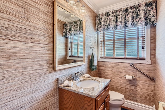 bathroom featuring crown molding, vanity, and toilet