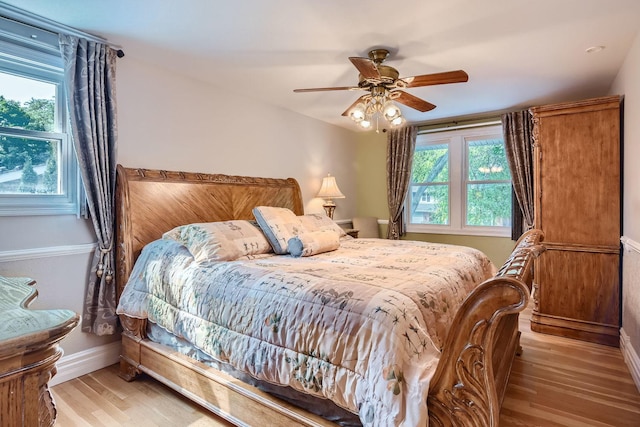 bedroom with ceiling fan and light wood-type flooring