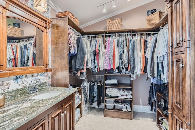 spacious closet featuring light tile patterned flooring and sink