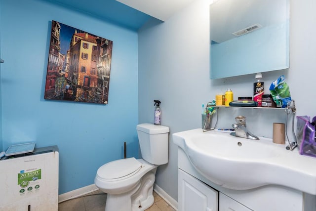 bathroom featuring vanity, toilet, and tile patterned flooring