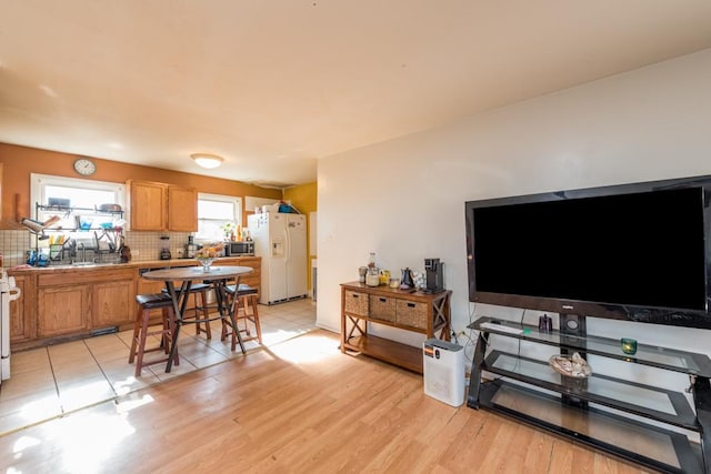 living room with sink and light wood-type flooring