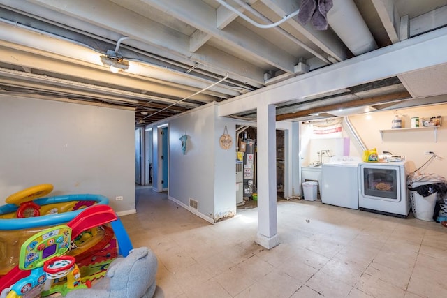 basement featuring washing machine and dryer and gas water heater