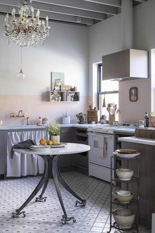 kitchen with white gas range and wall chimney range hood