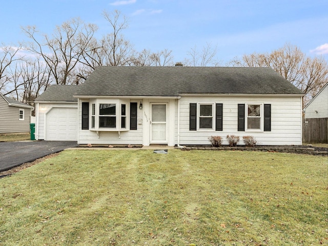 single story home featuring a garage and a front lawn