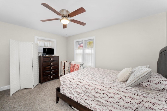 bedroom with ceiling fan and light carpet